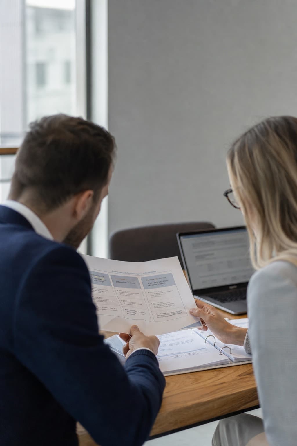 Consultants reviewing a strategy document in a Hong Kong office.